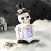 Glitzhome 10.25 in. H Halloween Lighted Resin Skull Reading Book Table Decor 2006200032
